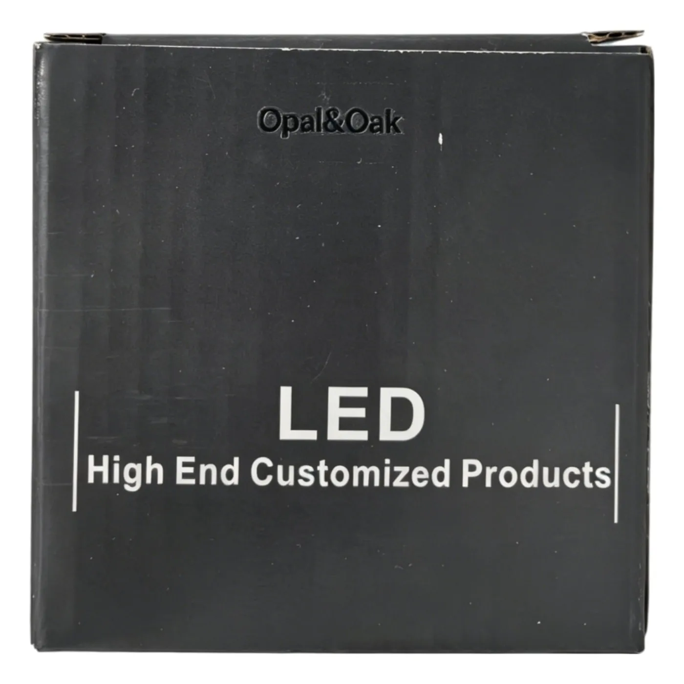 The front of the black box a Opal&Oak spotlight is supplied in, with the brand printed towards the top of the face