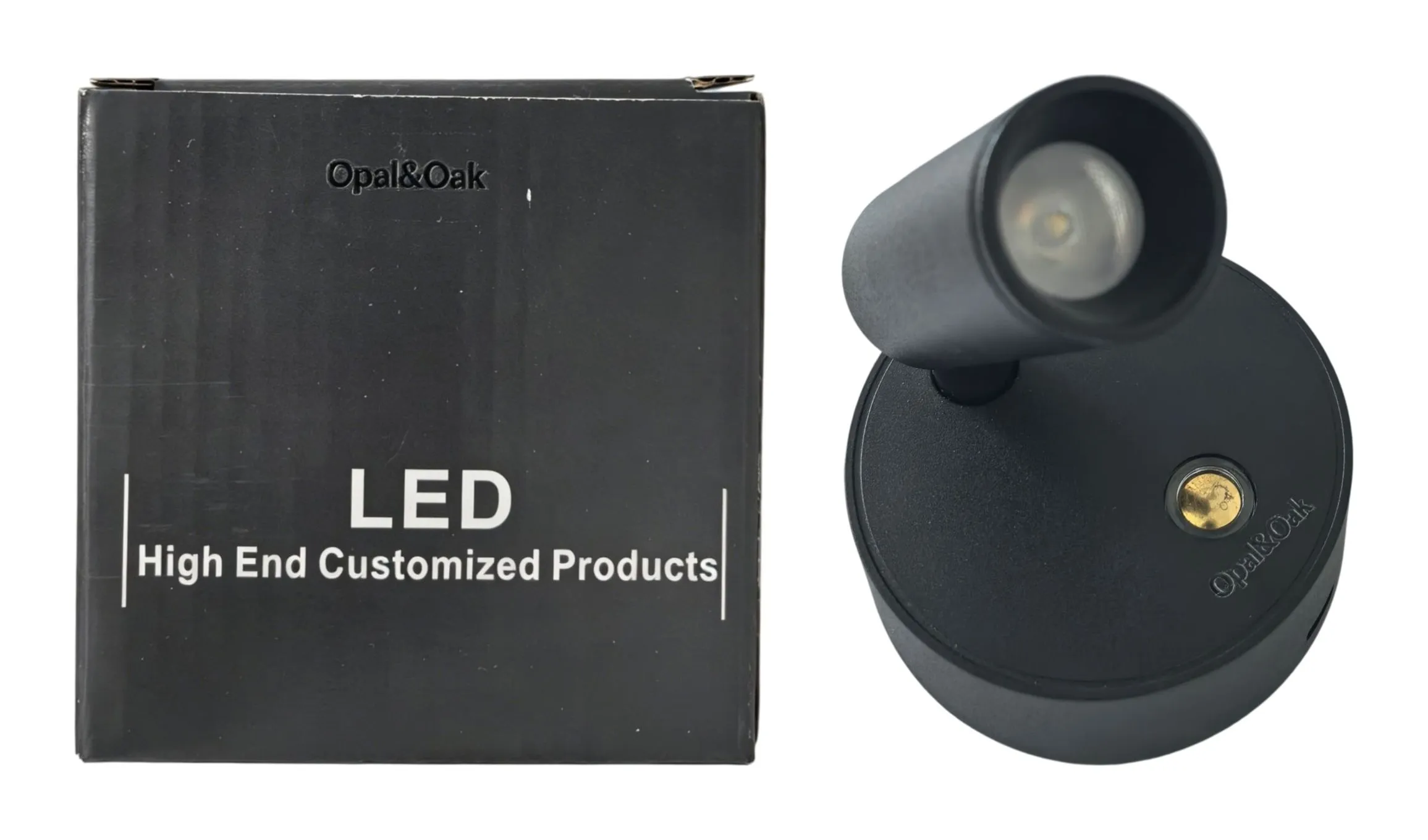 The black Opal&Oak spotlight standing beside the box it is supplied in